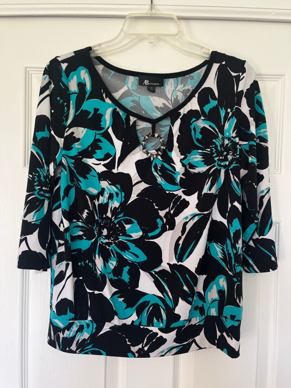 Floral print blouse with decorative circle ring detail